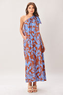 Woman wearing a blue and brown floral one-shoulder midi dress featuring bow tie shoulder and side pockets | Flying Tomato