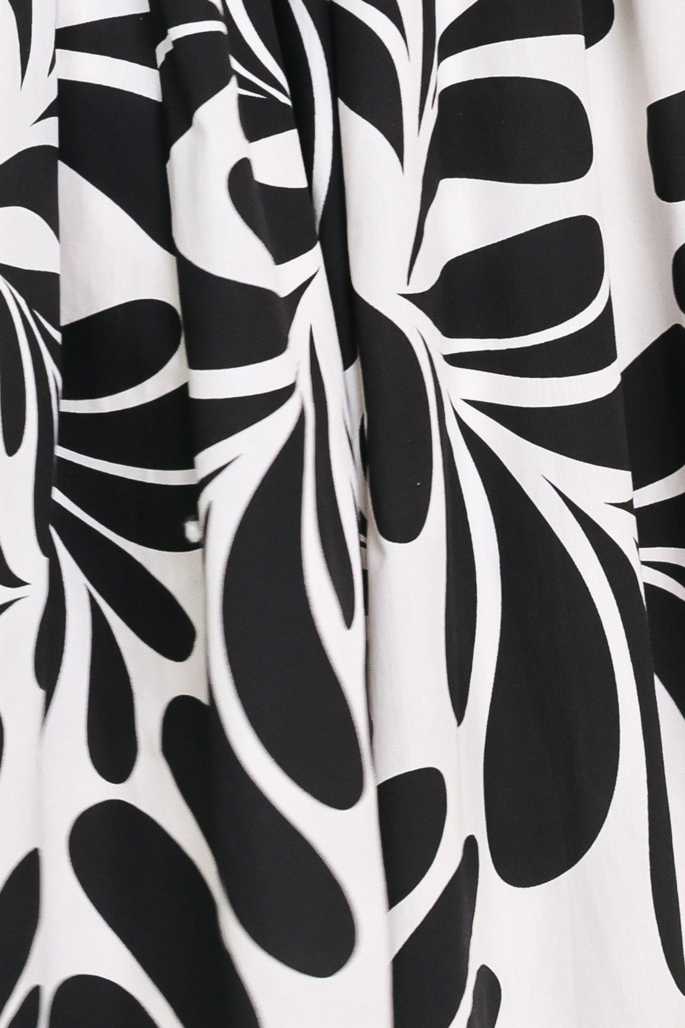 Close up of a black and white maxi dress featuring square neckline, sleeveless, full skirt, cut out back and button zipper closure | Flying Tomato