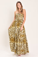 Woman wearing a leopard print maxi dress featuring halter neckline, front center cut out, ruffle hem and smocked back bodice | Flying Tomato