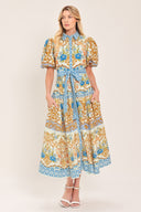 Woman wearing a patterned midi shirt dress with short sleeve and self sash tie | Flying Tomato