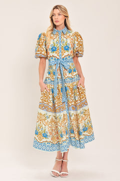 Woman wearing a patterned midi shirt dress with short sleeve and self sash tie | Flying Tomato