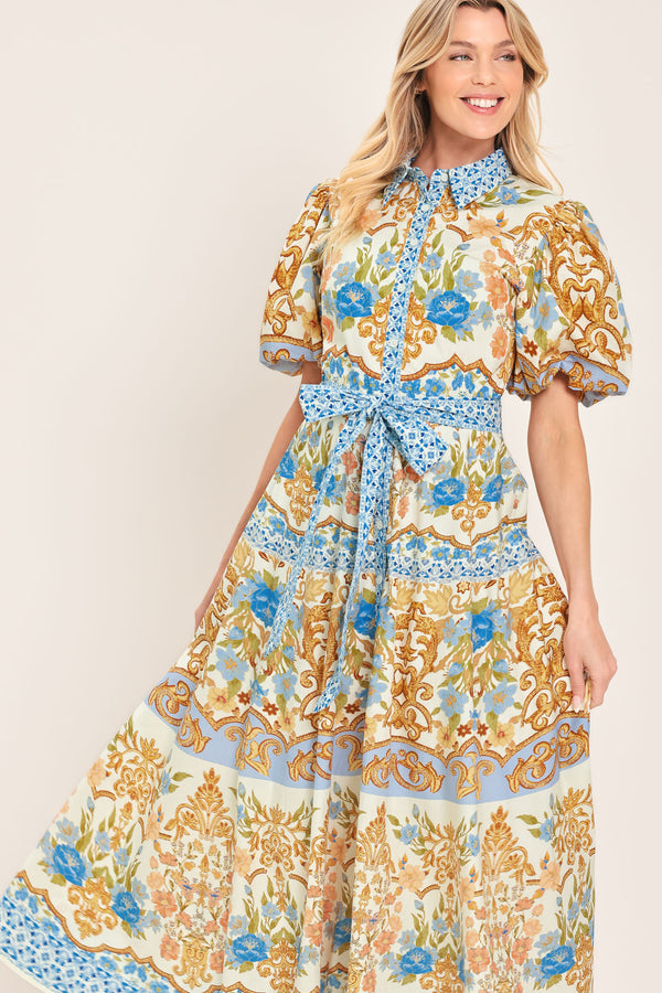 Woman wearing a patterned midi shirt dress with short sleeve and self sash tie | Flying Tomato