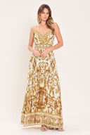 Woman wearing a gold and white baroque patterned maxi dress featuring surplice neckline, straps, pleated skirt and smocked back waistband | FLYING TOMATO