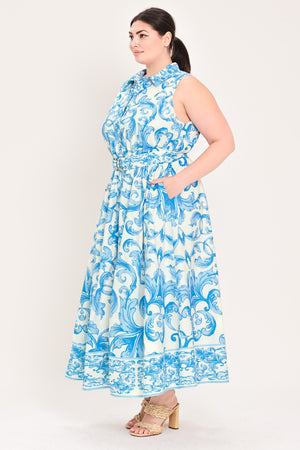 Woman wearing a blue and white patterned  maxi dress featuring collar, sleeveless, button down closure, self belt and full skirt  | Flying Tomato