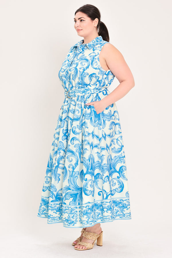 Woman wearing a blue and white patterned  maxi dress featuring collar, sleeveless, button down closure, self belt and full skirt  | Flying Tomato