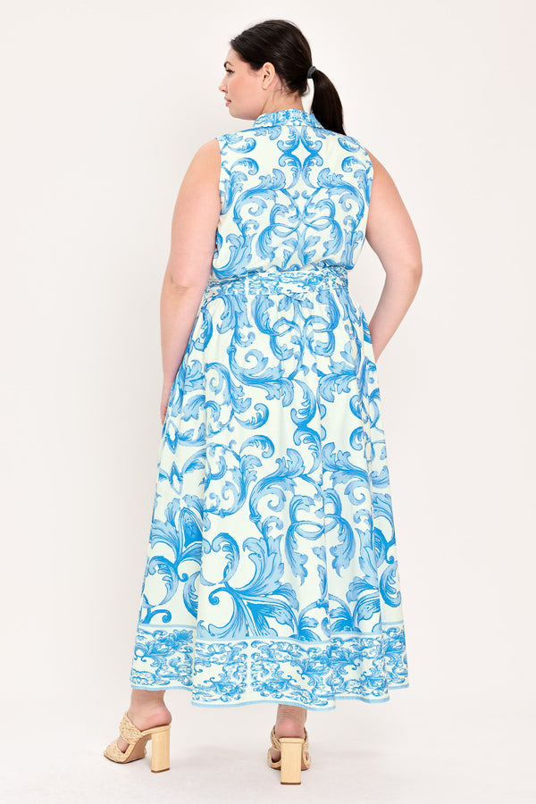 Woman wearing a blue and white patterned  maxi dress featuring collar, sleeveless, button down closure, self belt and full skirt  | Flying Tomato