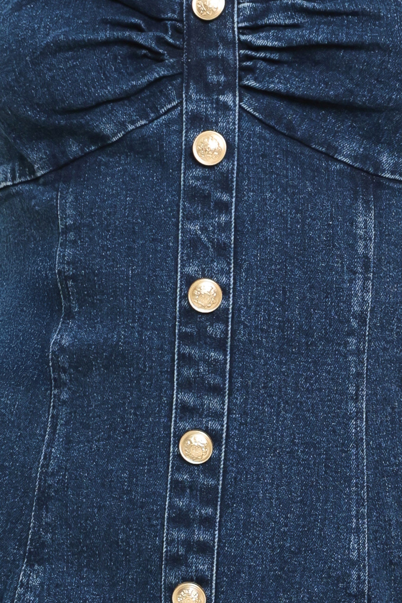 Close-up of a blue denim dress with gold buttons | Flying Tomato