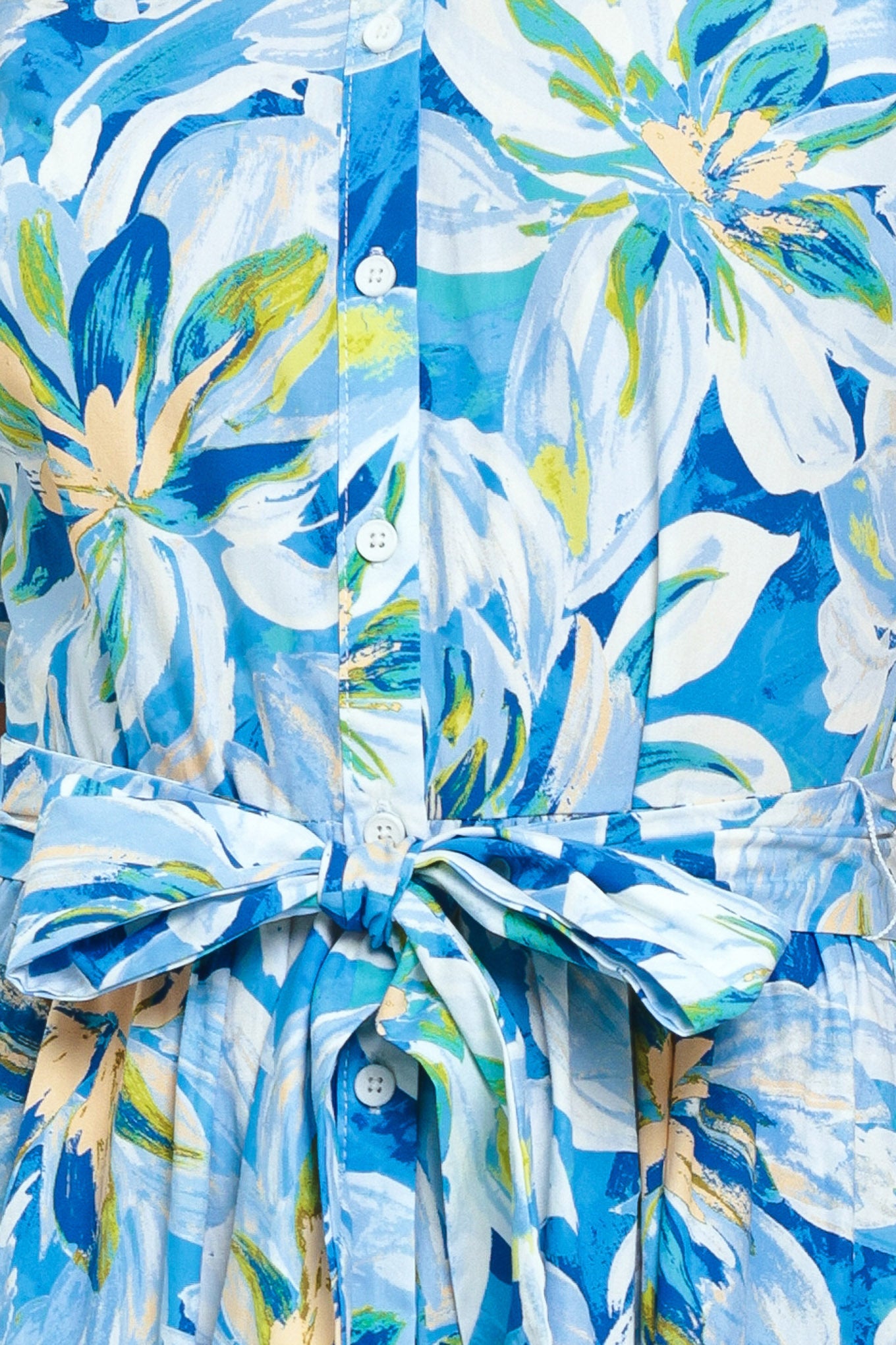 Close-up of a blue floral patterned fabric with buttons | Flying Tomato