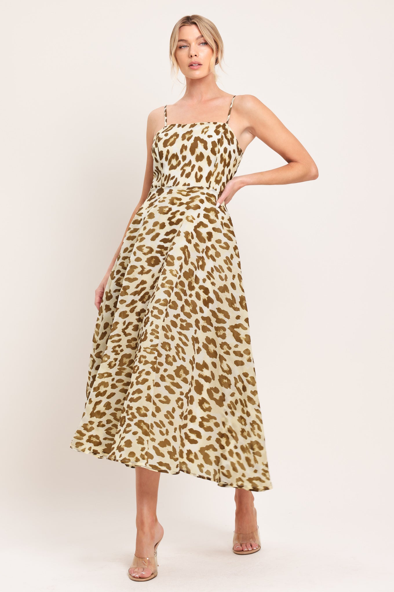 Woman wearing a leopard print midi dress featuring straight neckline, straps, full circle skirt and back zipper closure | Flying Tomato