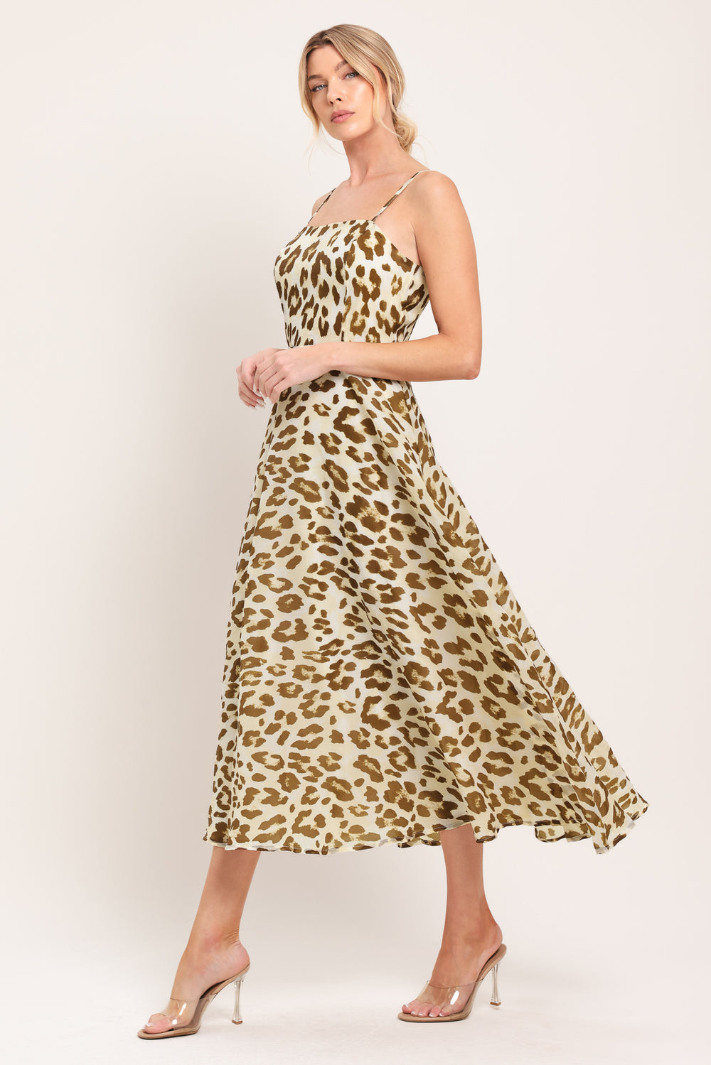 Woman wearing a leopard print midi dress featuring straight neckline, straps, full circle skirt and back zipper closure | Flying Tomato
