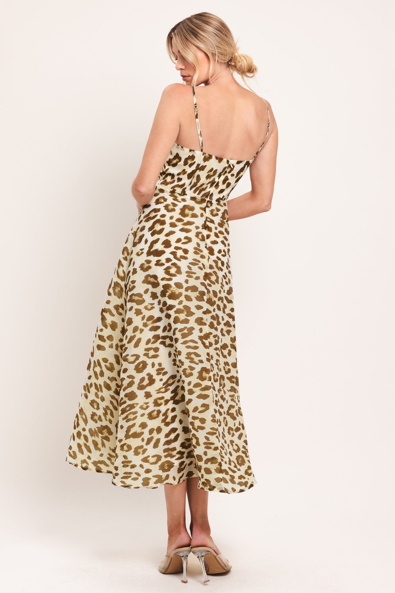Woman wearing a leopard print midi dress featuring straight neckline, straps, full circle skirt and back zipper closure | Flying Tomato