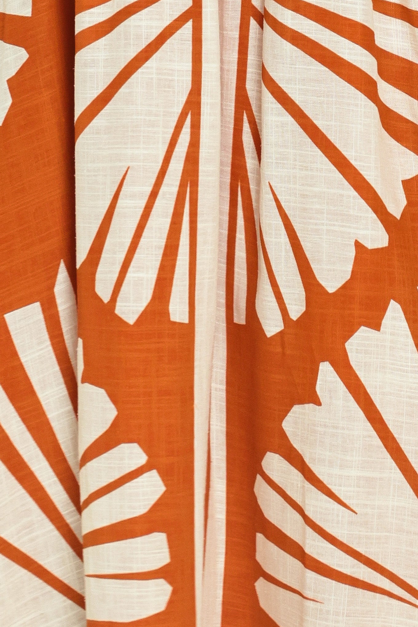 Woman wearing a maxi dress with an almond orange and white pattern | Flying Tomato