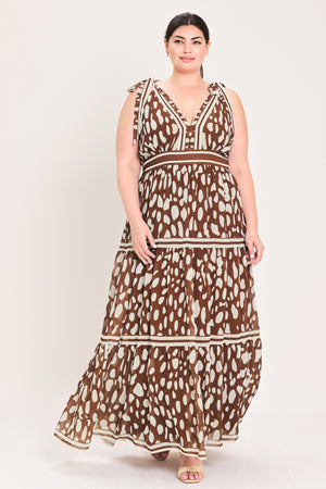 Woman wearing a brown and beige patterned dress on a white background