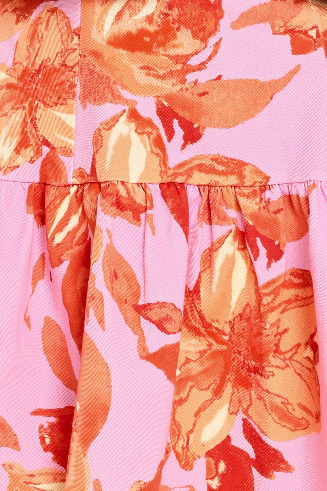 Woman wearing a lavender and coral floral printed mini dress featuring sweetheart neckline, short puff sleeve, ruffle hem and back zipper closure | Flying Tomato