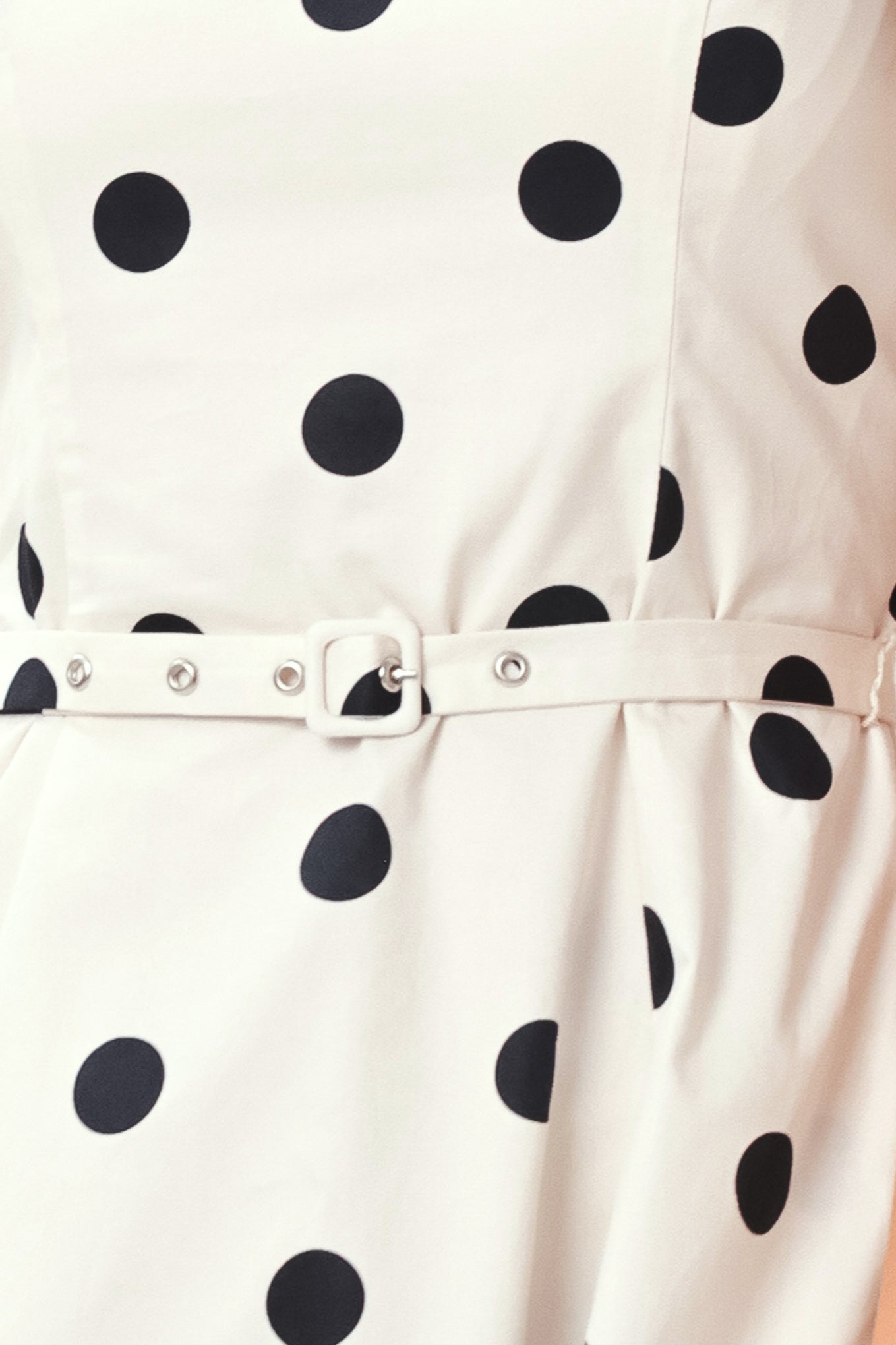Close up of white dress with black polka dots and a belt | Flying Tomato