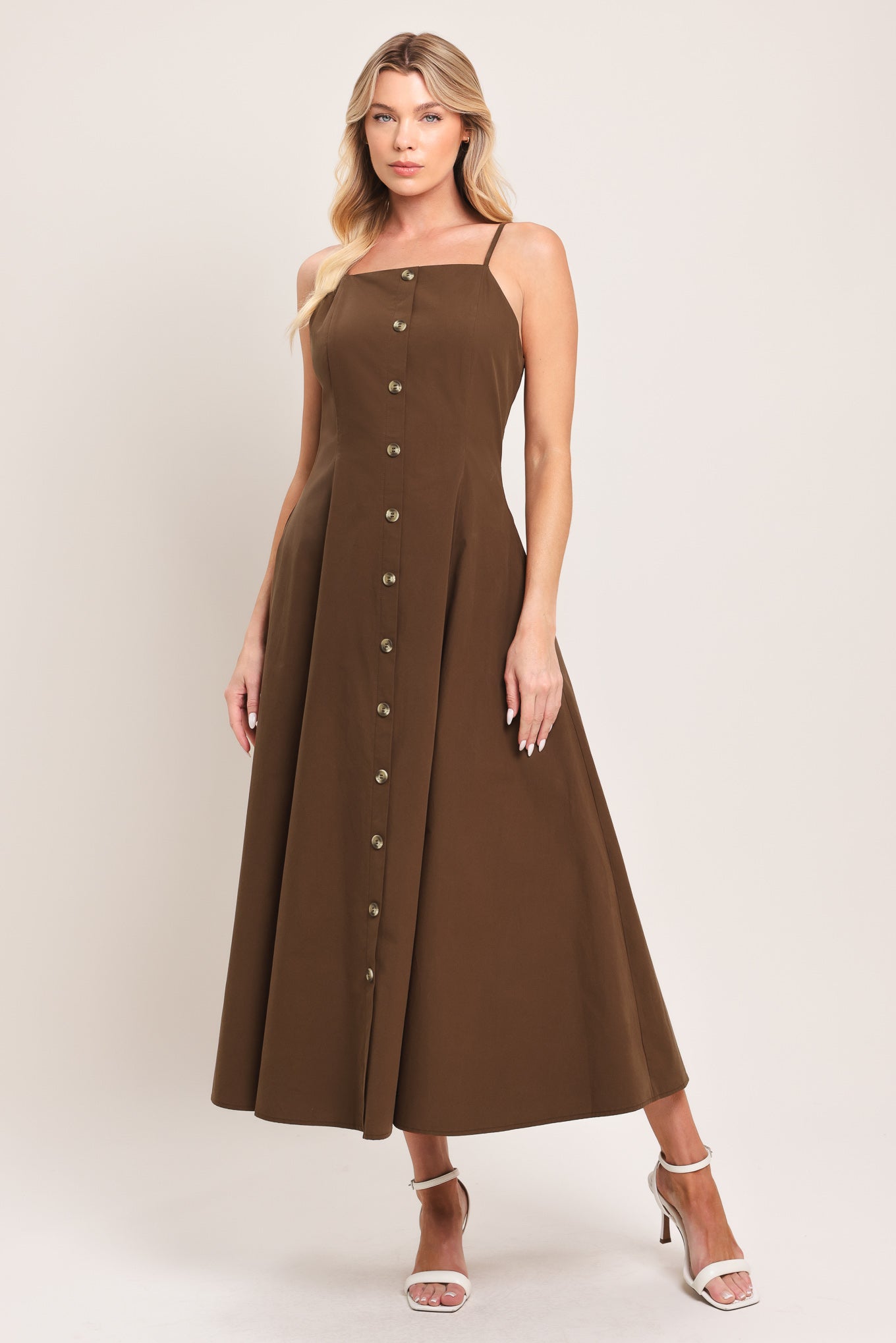 Woman wearing a brown midi dress featuring straight neckline, straps, front butt detail and back zipper closure | Flying Tomato