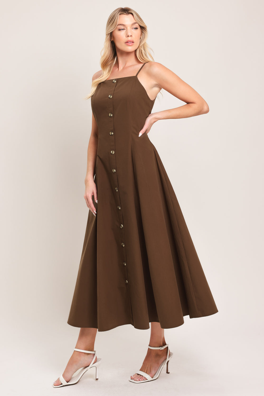 Woman wearing a brown midi dress featuring straight neckline, straps, front butt detail and back zipper closure | Flying Tomato