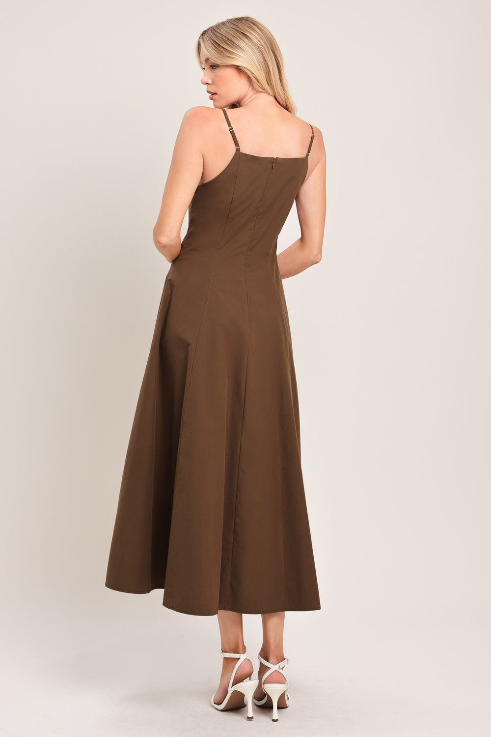 Woman wearing a brown midi dress featuring straight neckline, straps, front butt detail and back zipper closure | Flying Tomato