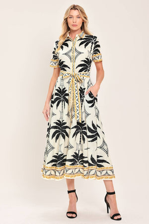 Woman wearing a black and white palm patterned shirt midi dress with short sleeve and self sash tie | Flying Tomato