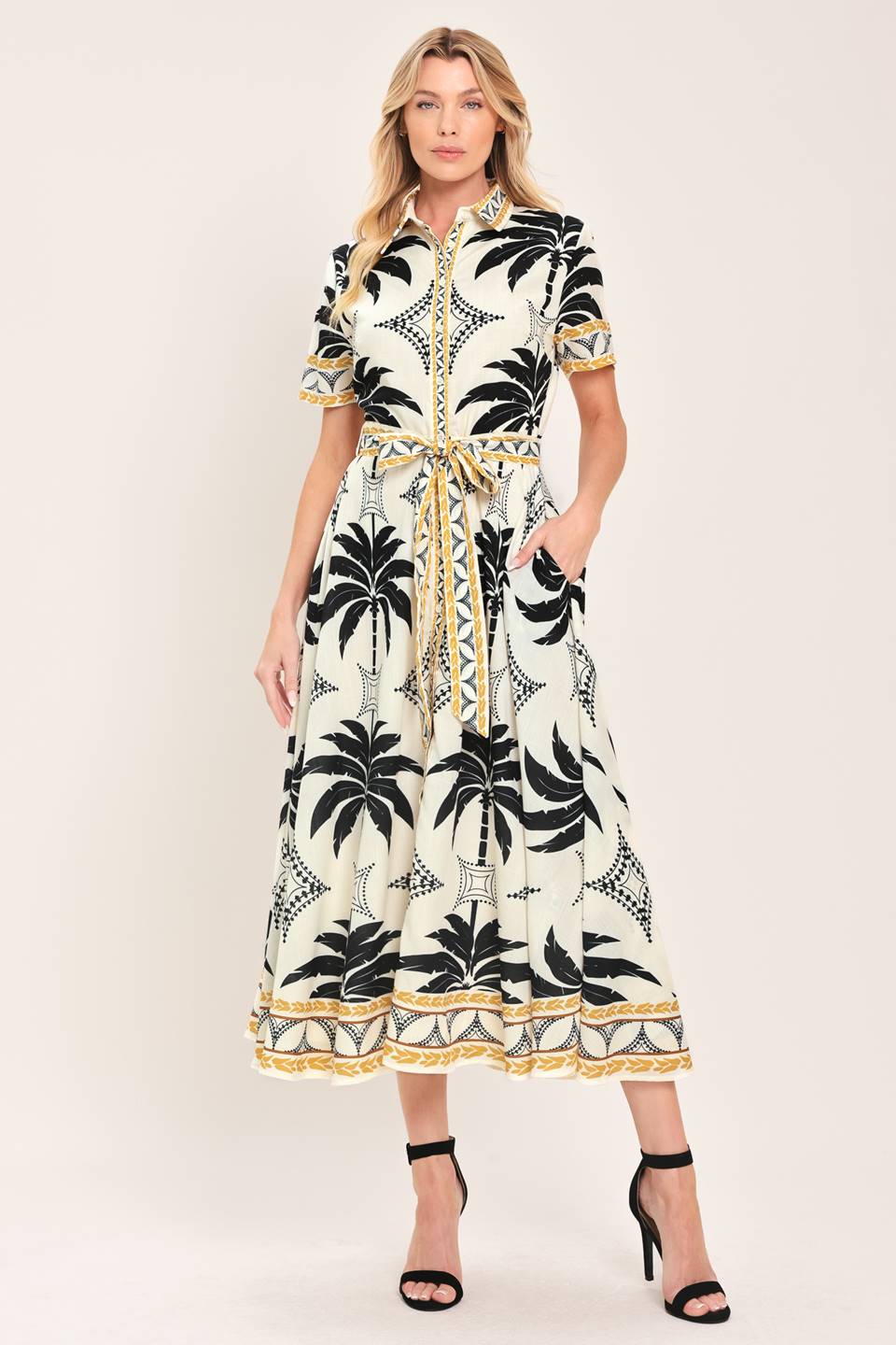 Woman wearing a black and white palm patterned shirt midi dress with short sleeve and self sash tie | Flying Tomato