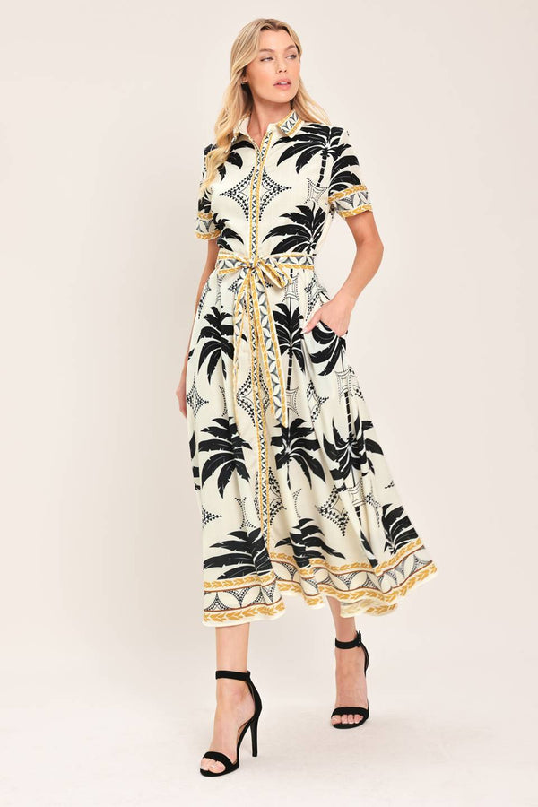 Woman wearing a black and white palm patterned shirt midi dress with short sleeve and self sash tie | Flying Tomato
