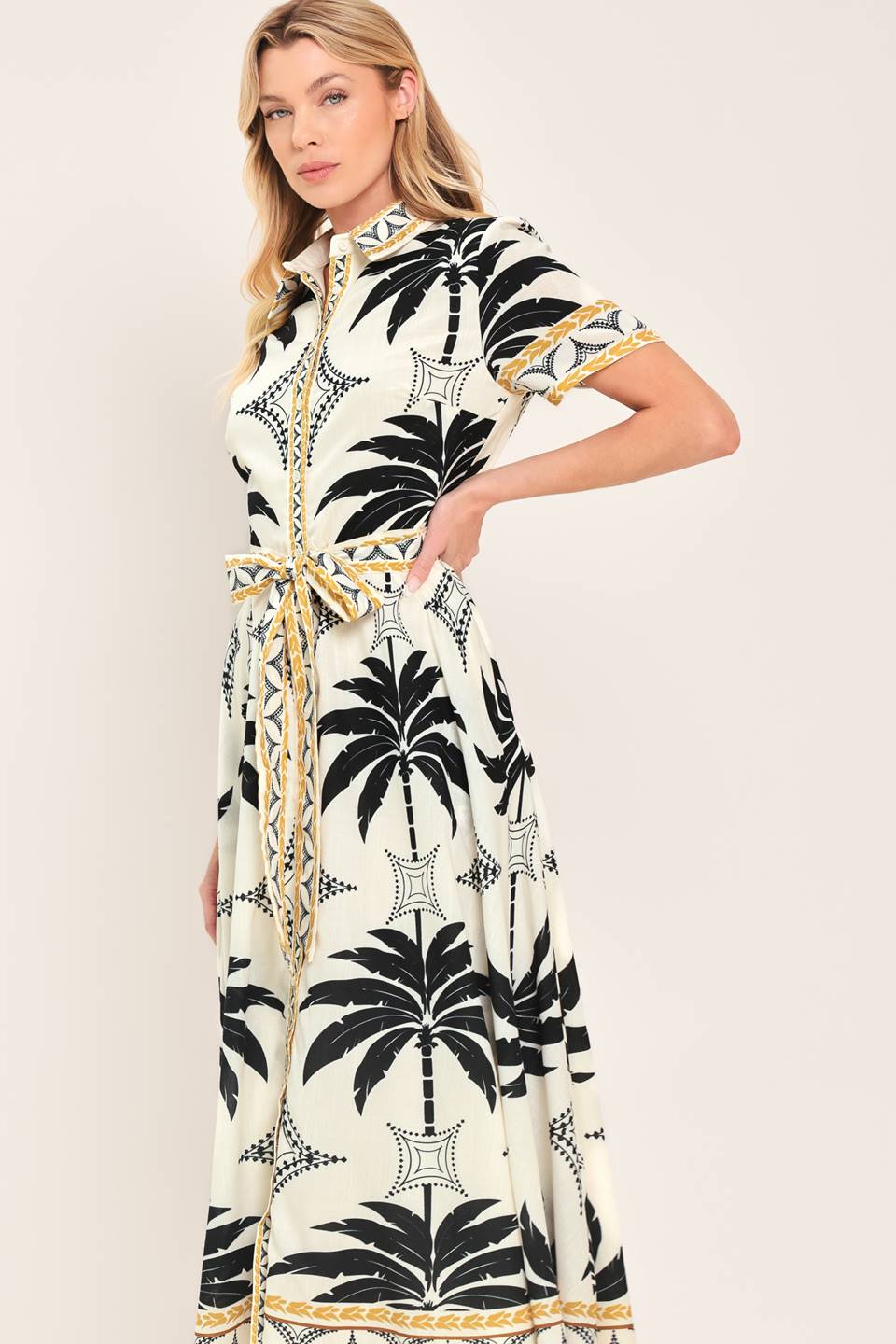 Woman wearing a black and white palm patterned shirt midi dress with short sleeve and self sash tie | Flying Tomato