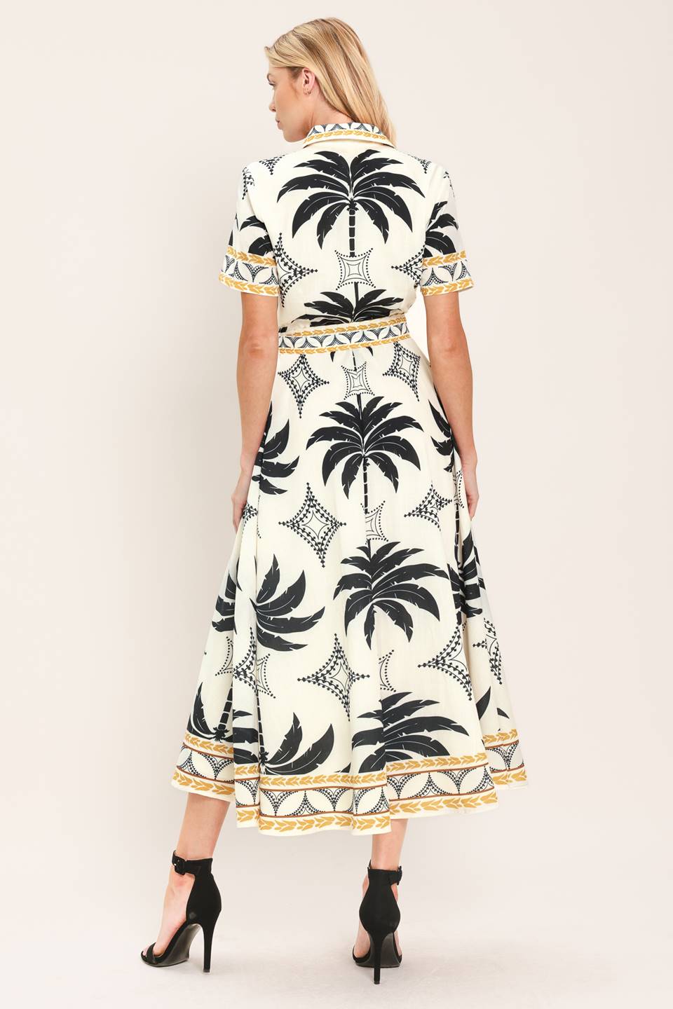 Woman wearing a black and white palm patterned shirt midi dress with short sleeve and self sash tie | Flying Tomato