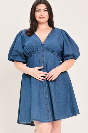 Woman wearing a denim mini dress featuring V neckline, short puff sleeve, button down detail, circle skirt and back zipper closure | Flying Tomato