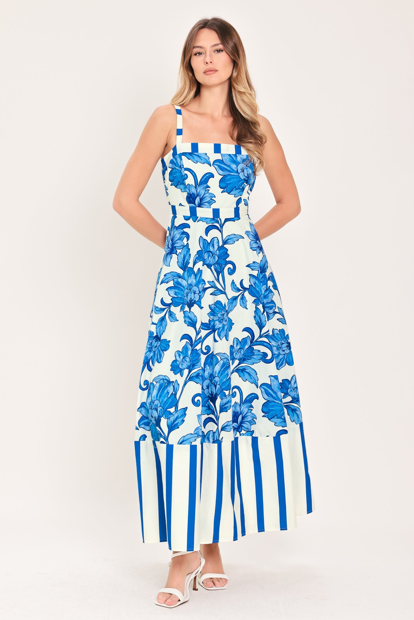 Woman wearing a striped blue and white dress with blue floral pattern on the center | Flying Tomato