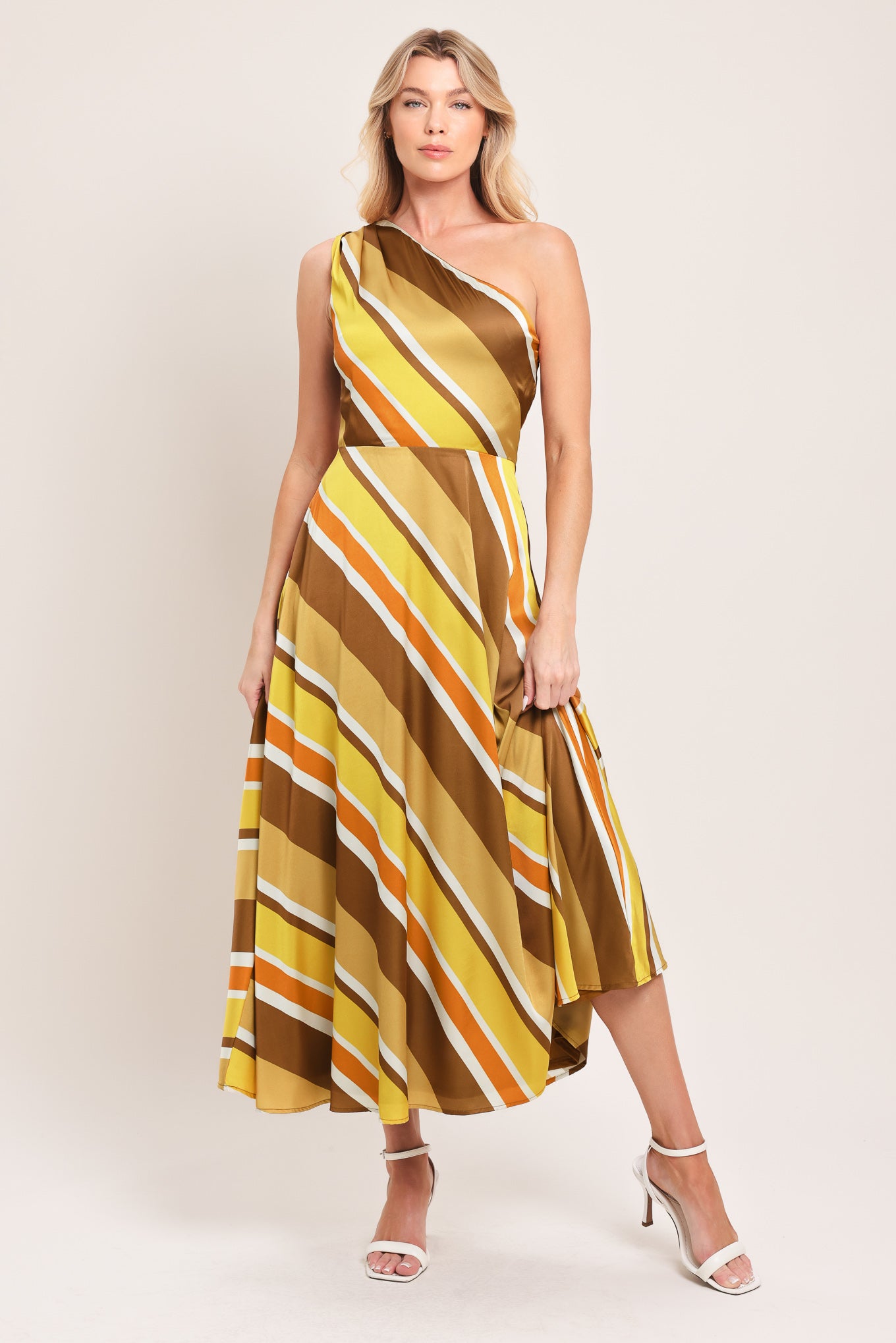 Woman wearing a one-shoulder striped midi dress featuring a side zipper and full circle skirt | Flying Tomato