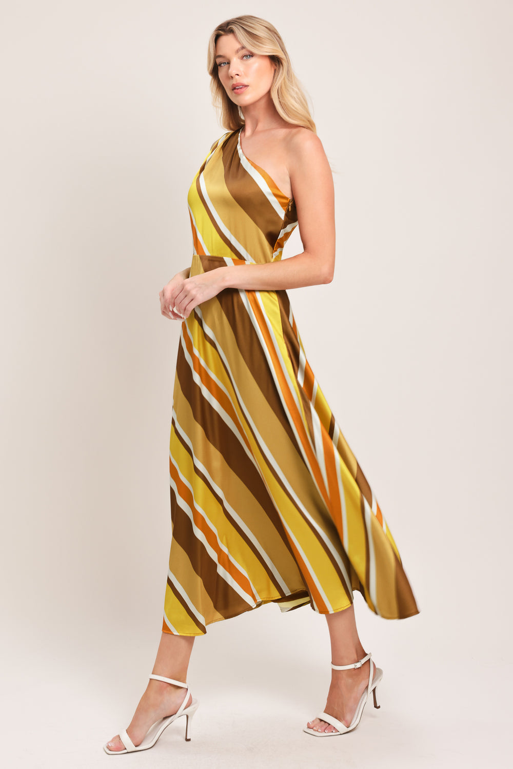 Woman wearing a one-shoulder striped midi dress featuring a side zipper and full circle skirt | Flying Tomato