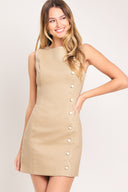 Woman wearing a beige sleeveless mini dress featuring round neckline, side scallop placket with button detail and back zipper closure | Flying Tomato