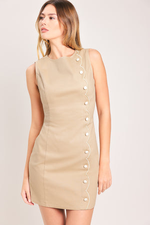 Woman wearing a beige sleeveless mini dress featuring round neckline, side scallop placket with button detail and back zipper closure | Flying Tomato