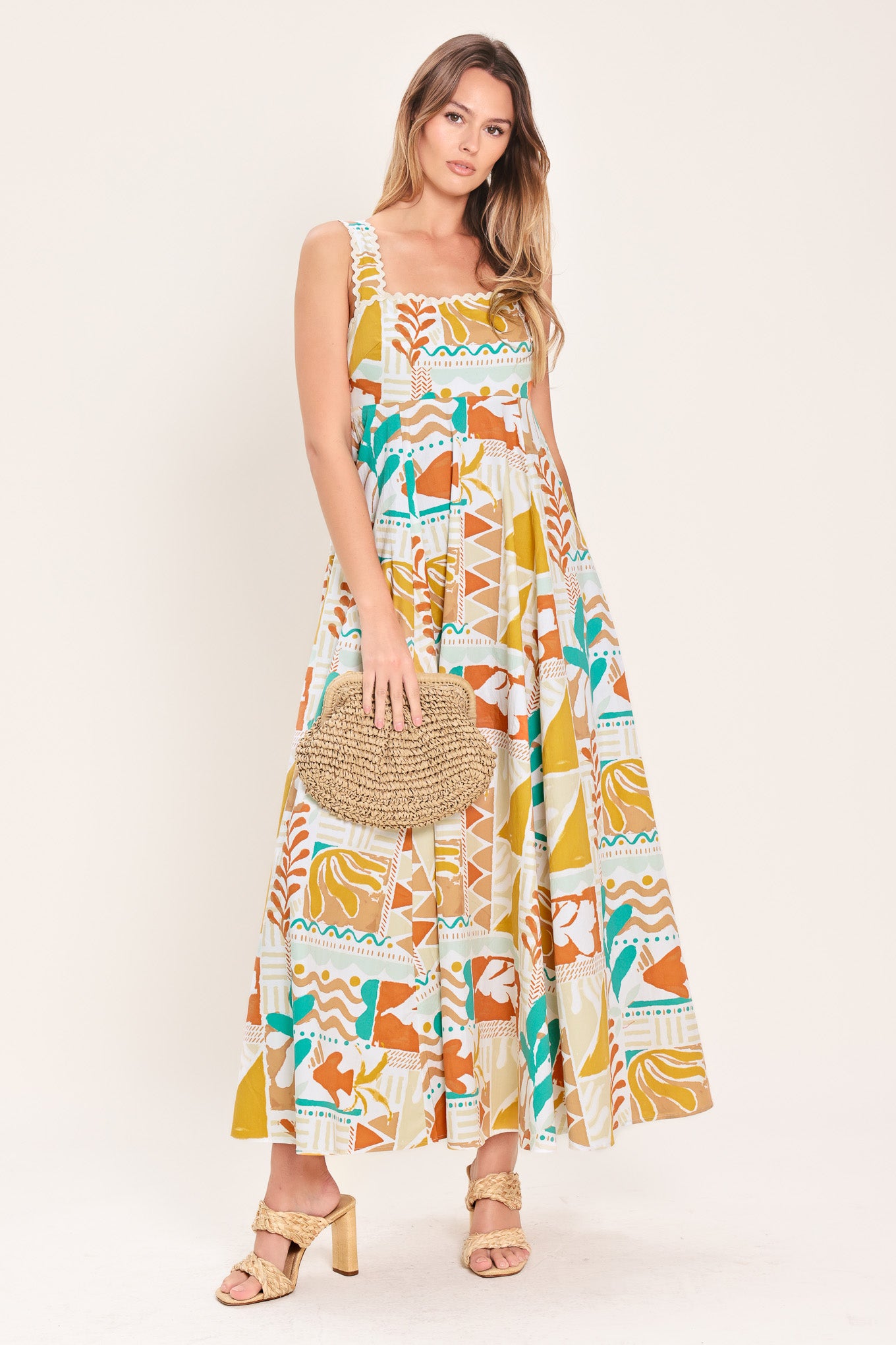 Woman wearing a printed woven midi dress featuring straight neckline with ric-rac ribbon trim, circle skirt and smocked back bodice | Flying Tomato