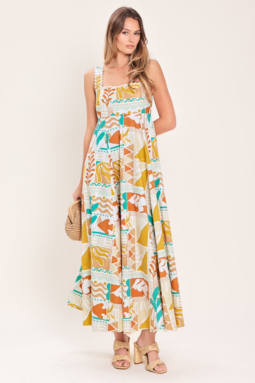 Woman wearing a printed woven midi dress featuring straight neckline with ric-rac ribbon trim, circle skirt and smocked back bodice | Flying Tomato
