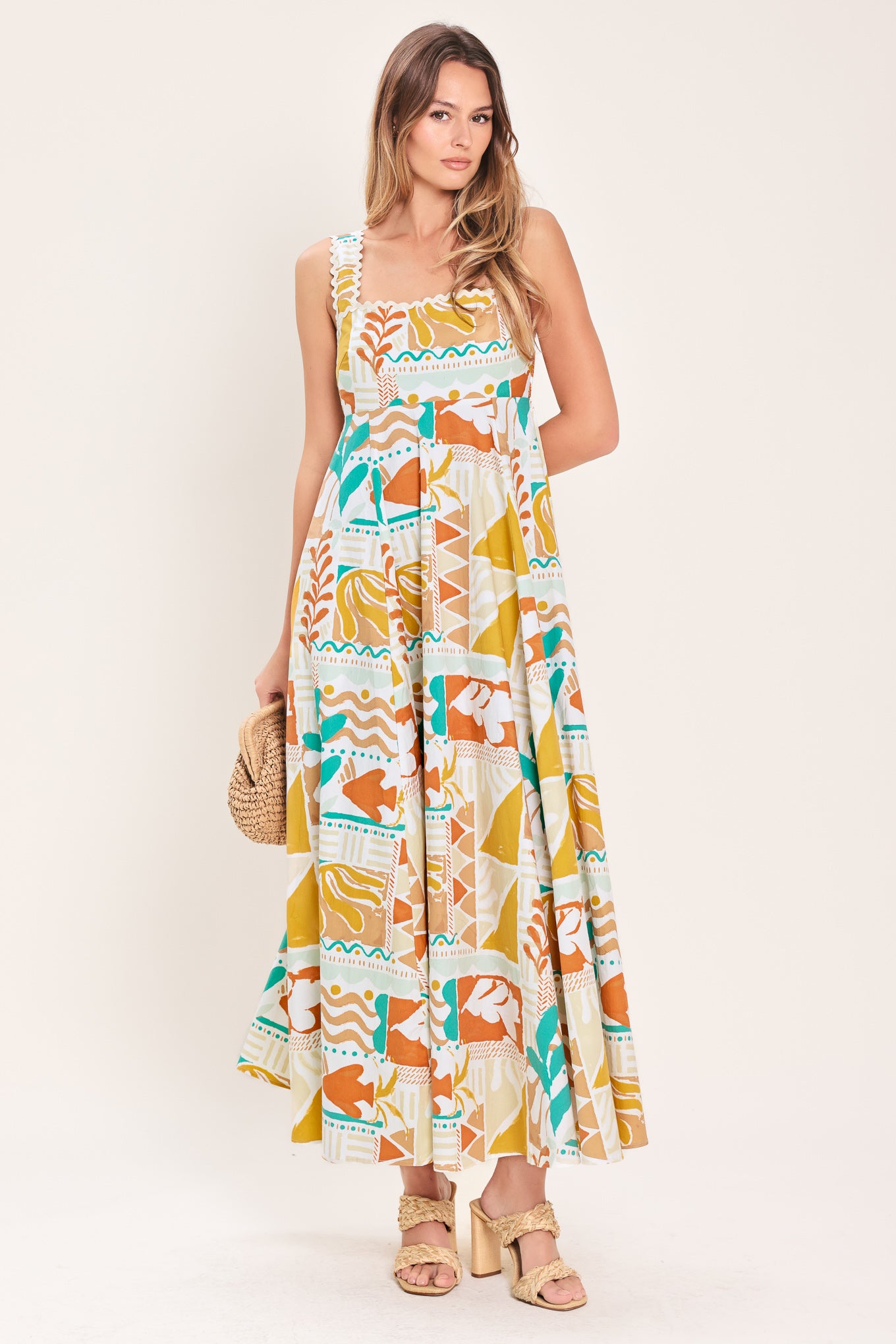 Woman wearing a printed woven midi dress featuring straight neckline with ric-rac ribbon trim, circle skirt and smocked back bodice | Flying Tomato
