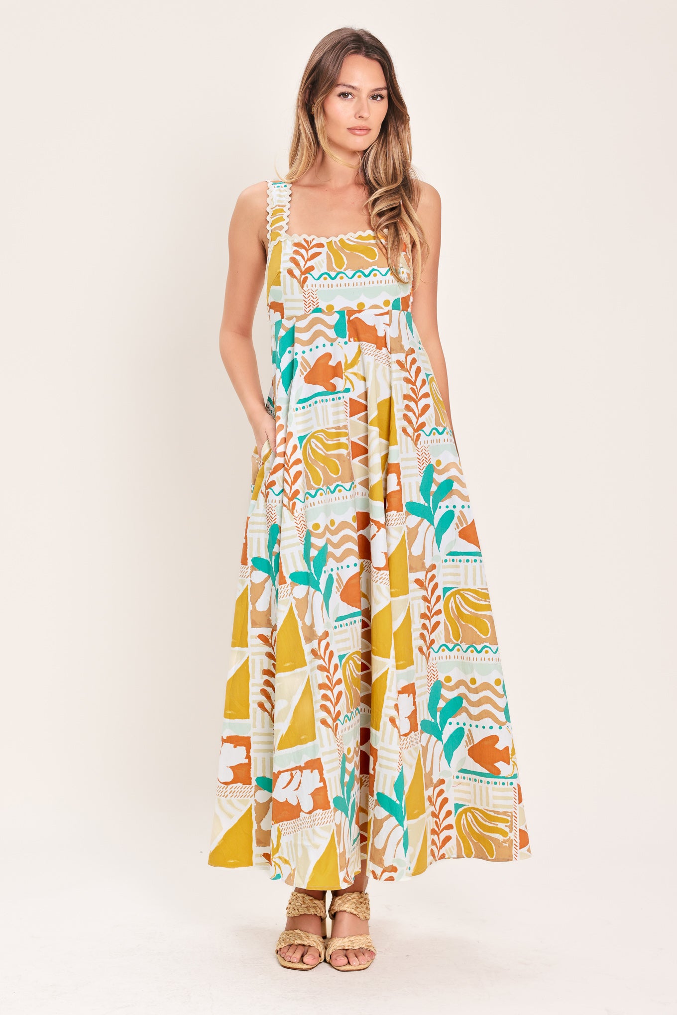 Woman wearing a printed woven midi dress featuring straight neckline with ric-rac ribbon trim, circle skirt and smocked back bodice | Flying Tomato