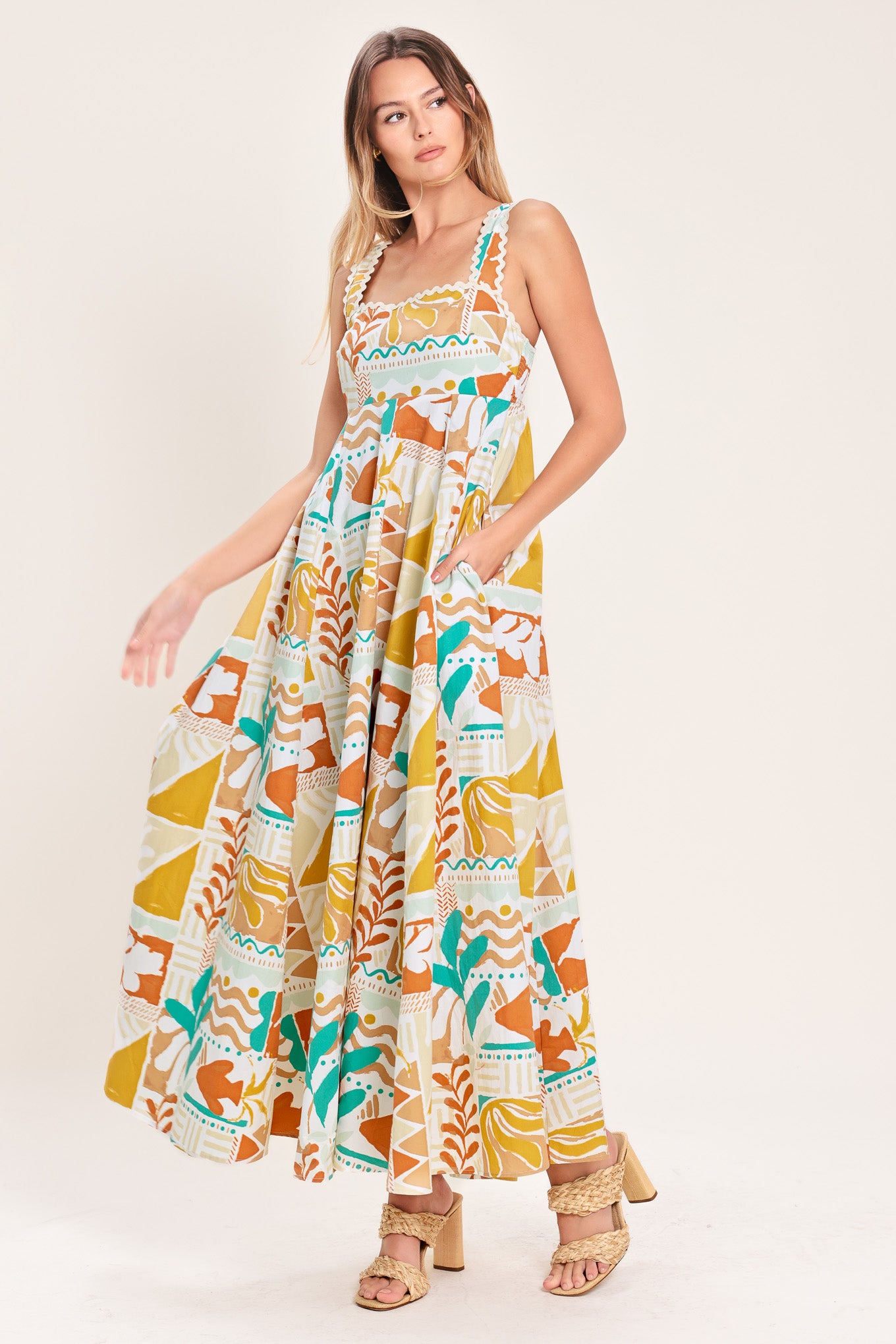 Woman wearing a printed woven midi dress featuring straight neckline with ric-rac ribbon trim, circle skirt and smocked back bodice | Flying Tomato