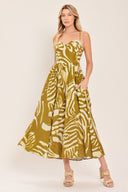 Woman wearing a mustard yellow and white patterned midi dress featuring bustier top, full skirt, bare back with lace up tie and zipper closure | Flying Tomato