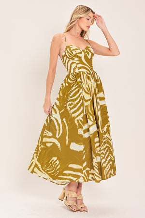 Woman wearing a mustard yellow and white patterned midi dress featuring bustier top, full skirt, bare back with lace up tie and zipper closure | Flying Tomato