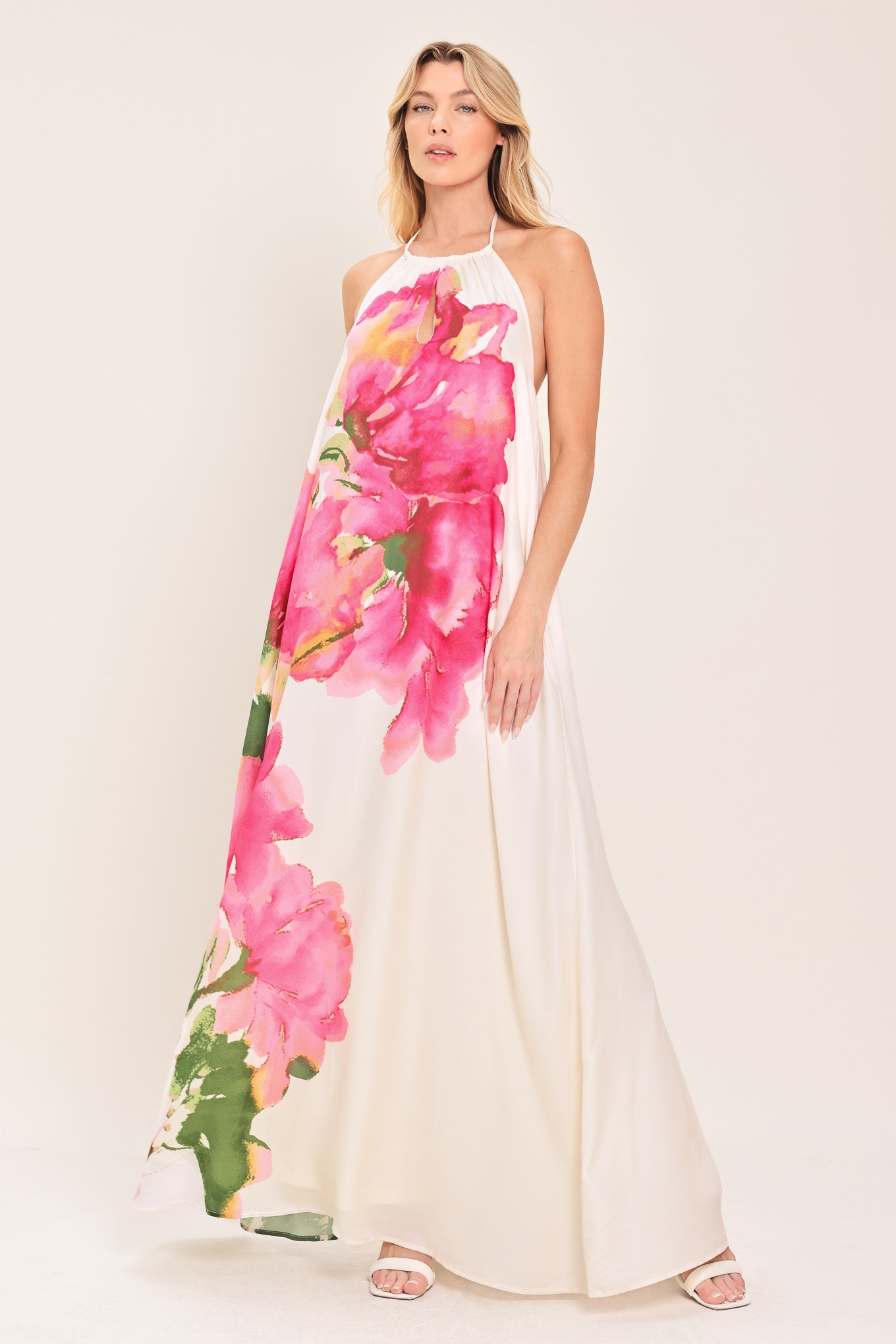 Woman wearing a floral maxi dress featuring halter neckline, bare back with tie | Flying Tomato