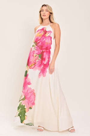 Woman wearing a floral maxi dress featuring halter neckline, bare back with tie | Flying Tomato