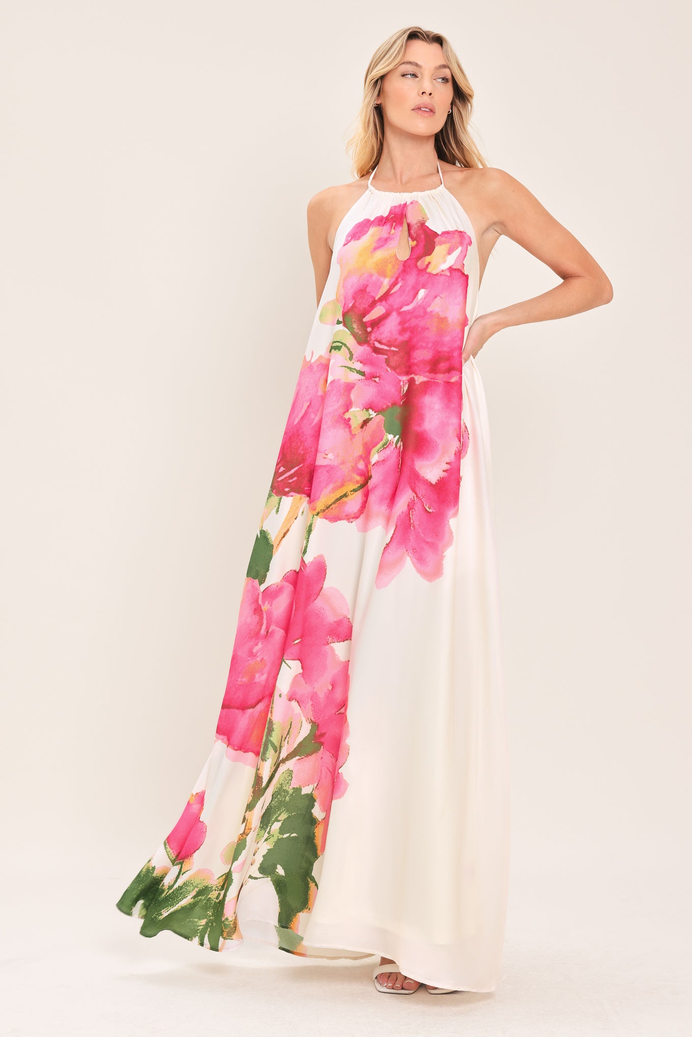 Woman wearing a floral maxi dress featuring halter neckline, bare back with tie | Flying Tomato