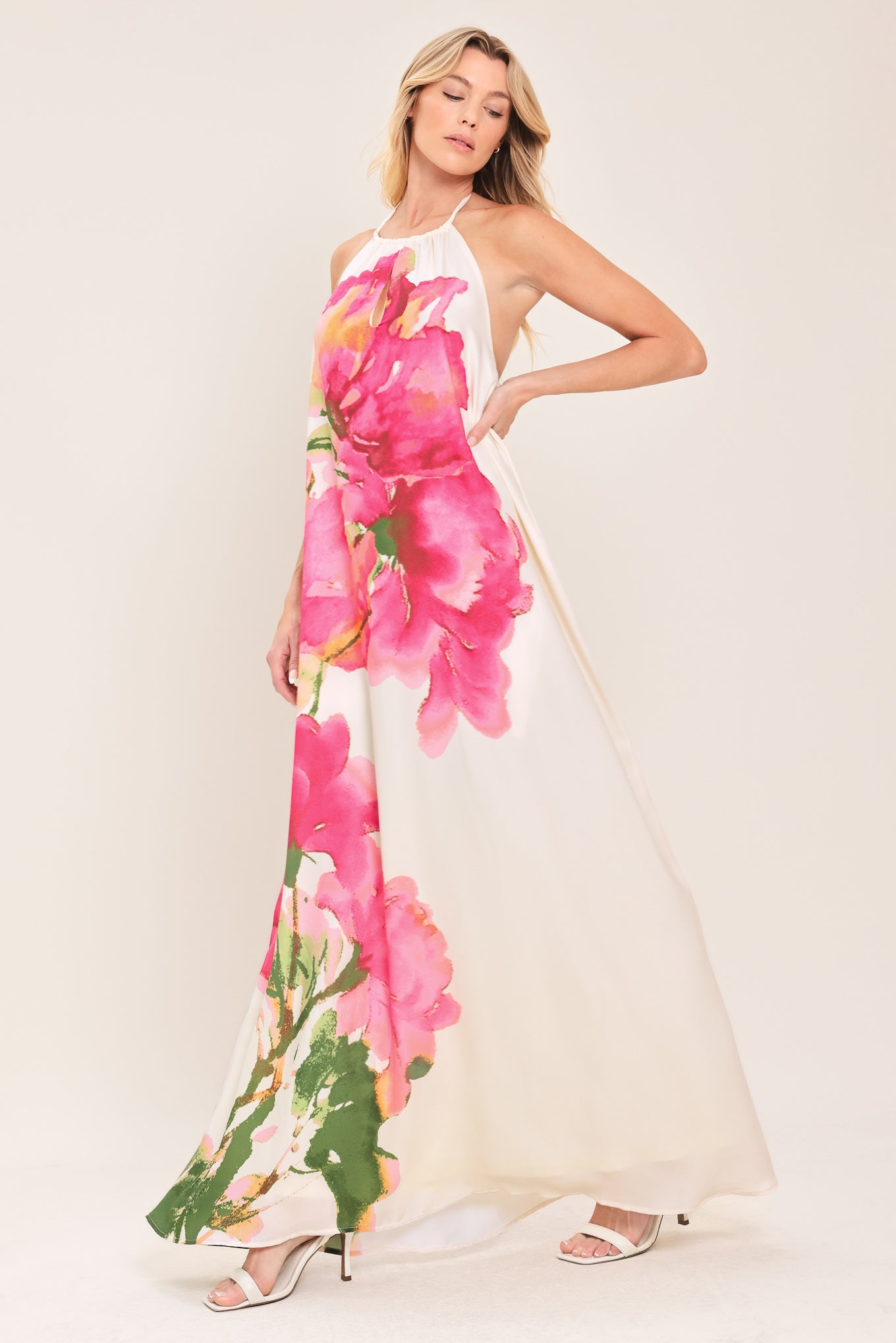 Woman wearing a floral maxi dress featuring halter neckline, bare back with tie | Flying Tomato