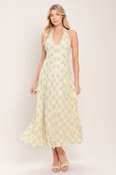 Woman wearing a yellow with blue floral lace midi dress featuring halter neckline, full circle skirt and back zipper closure with back neck tie | Flying Tomato