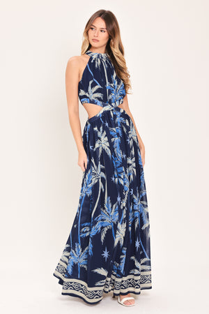Woman wearing a blue and navy tropical patterned dress with palm trees | Flying Tomato