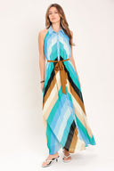 Woman wearing a sleeveless multicolor blue, teal, and brown striped maxi dress featuring halter neckline with collared finish, contrasting belt, and front button down | Flying Tomato