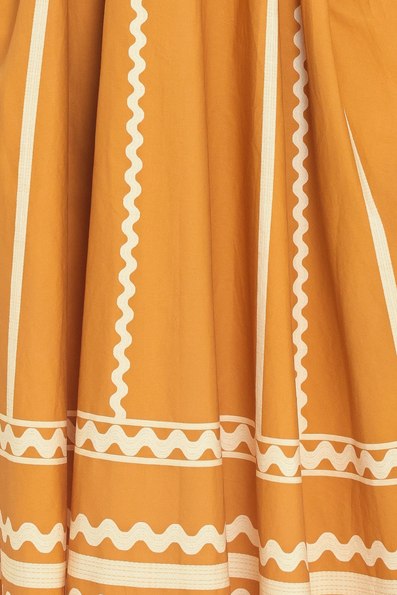 Woman wearing a mustard yellow midi dress with white patterns featuring V neckline, sleeveless, waist yoke, full skirt and smocked back waistband | Flying Tomato