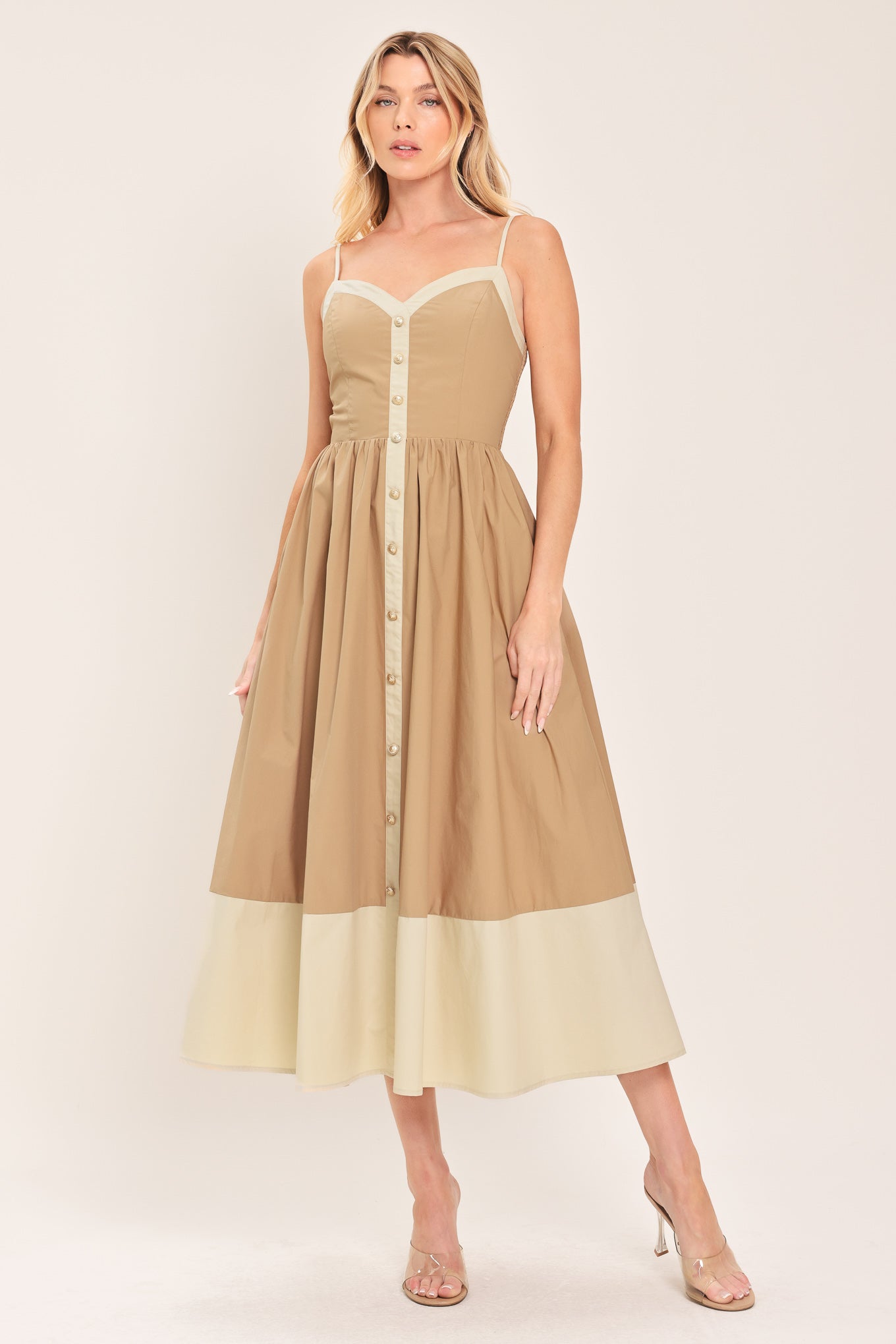 Woman wearing a beige color blocked midi dress featuring sweetheart neckline, straps, button down detail and smocked back bodice | Flying Tomato