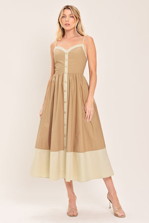 Woman wearing a beige color blocked midi dress featuring sweetheart neckline, straps, button down detail and smocked back bodice | Flying Tomato